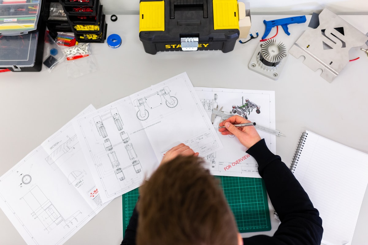 Engineer reviewing technical drawings with calipers